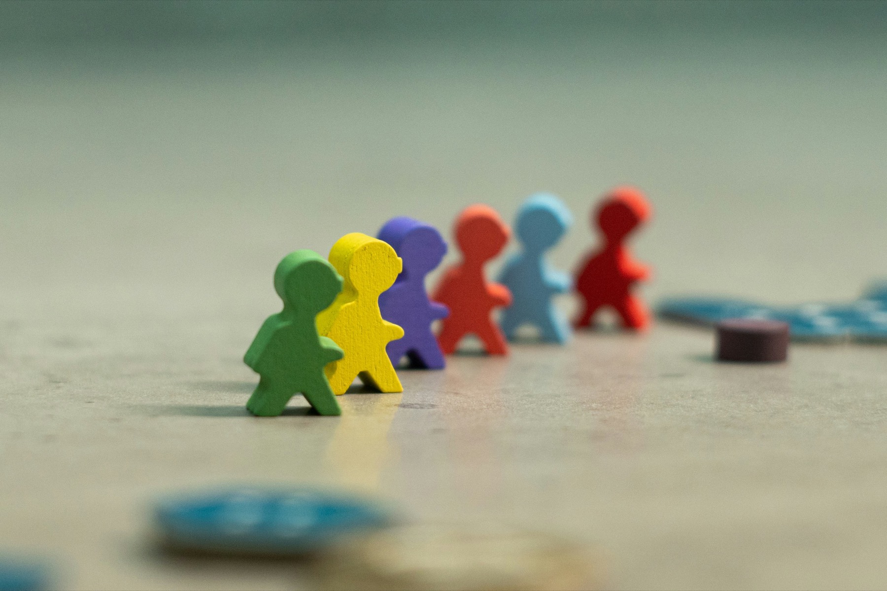 Colorful wooden figures lined up together on a table