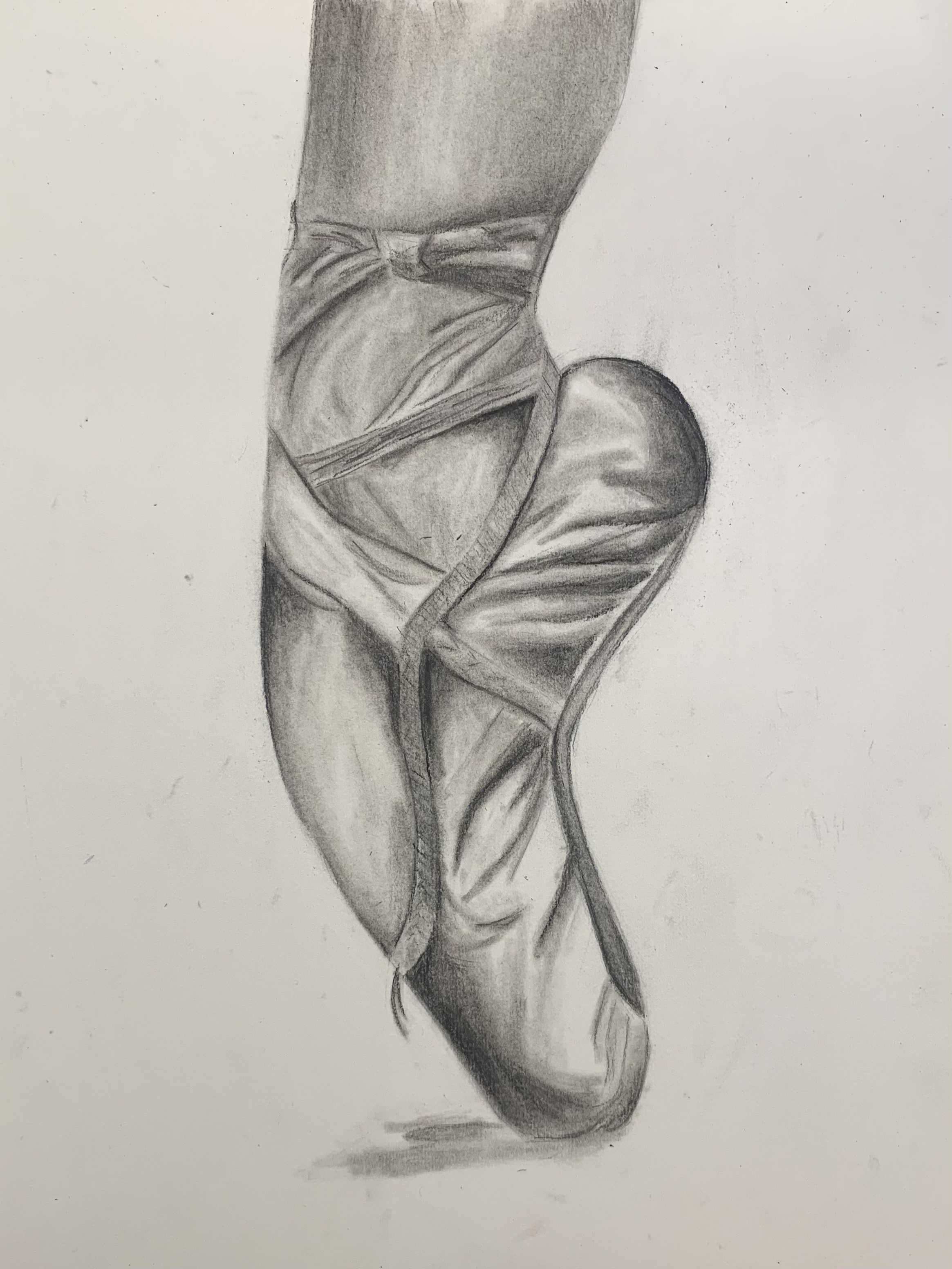 A pencil drawing of a ballet pointe shoe on pointe, with ribbons wrapped around the ankle