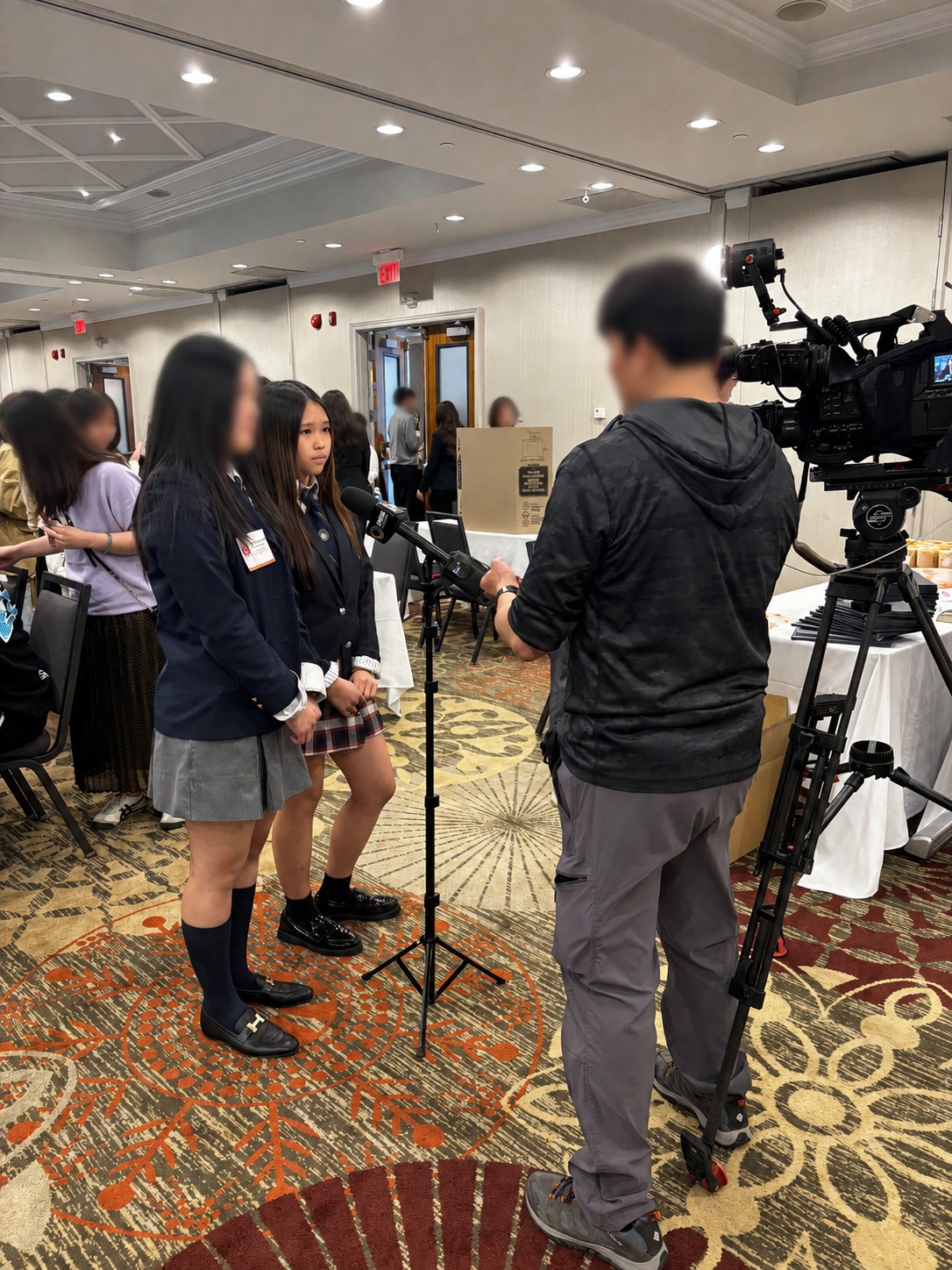 Mia being filmed for an interview at an event