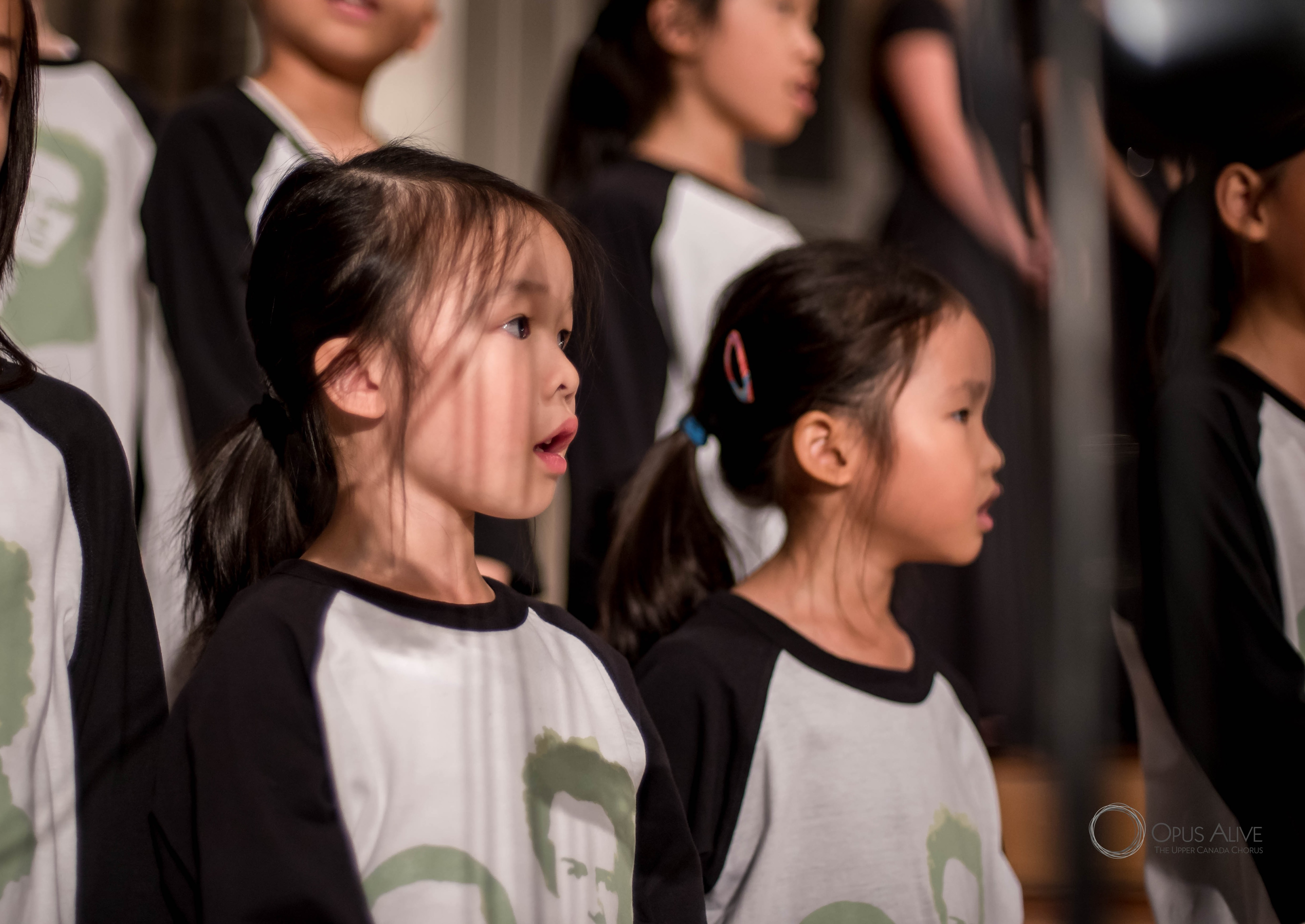 A young Mia singing on stage with her children's choir
