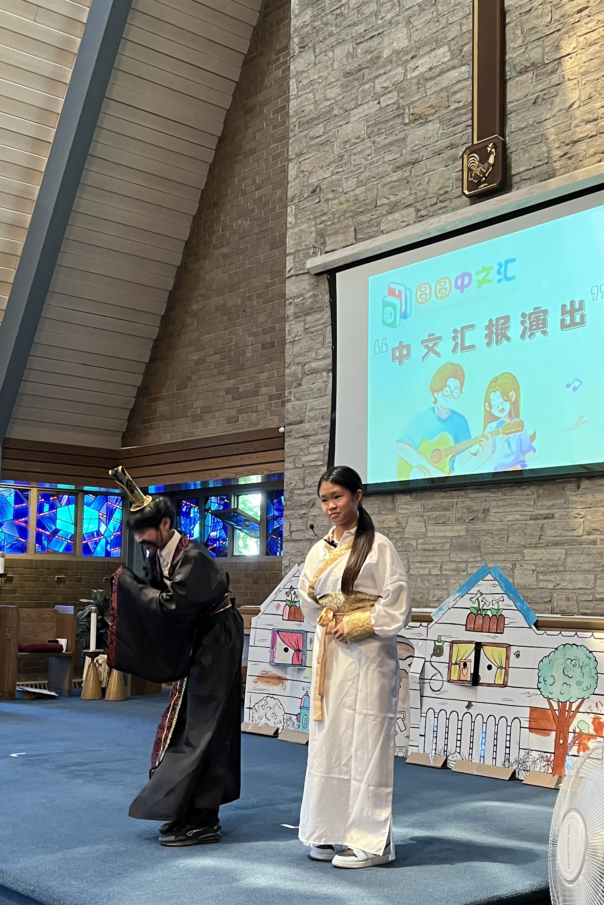 Mia performing in traditional costume in a Chinese-language theater performance