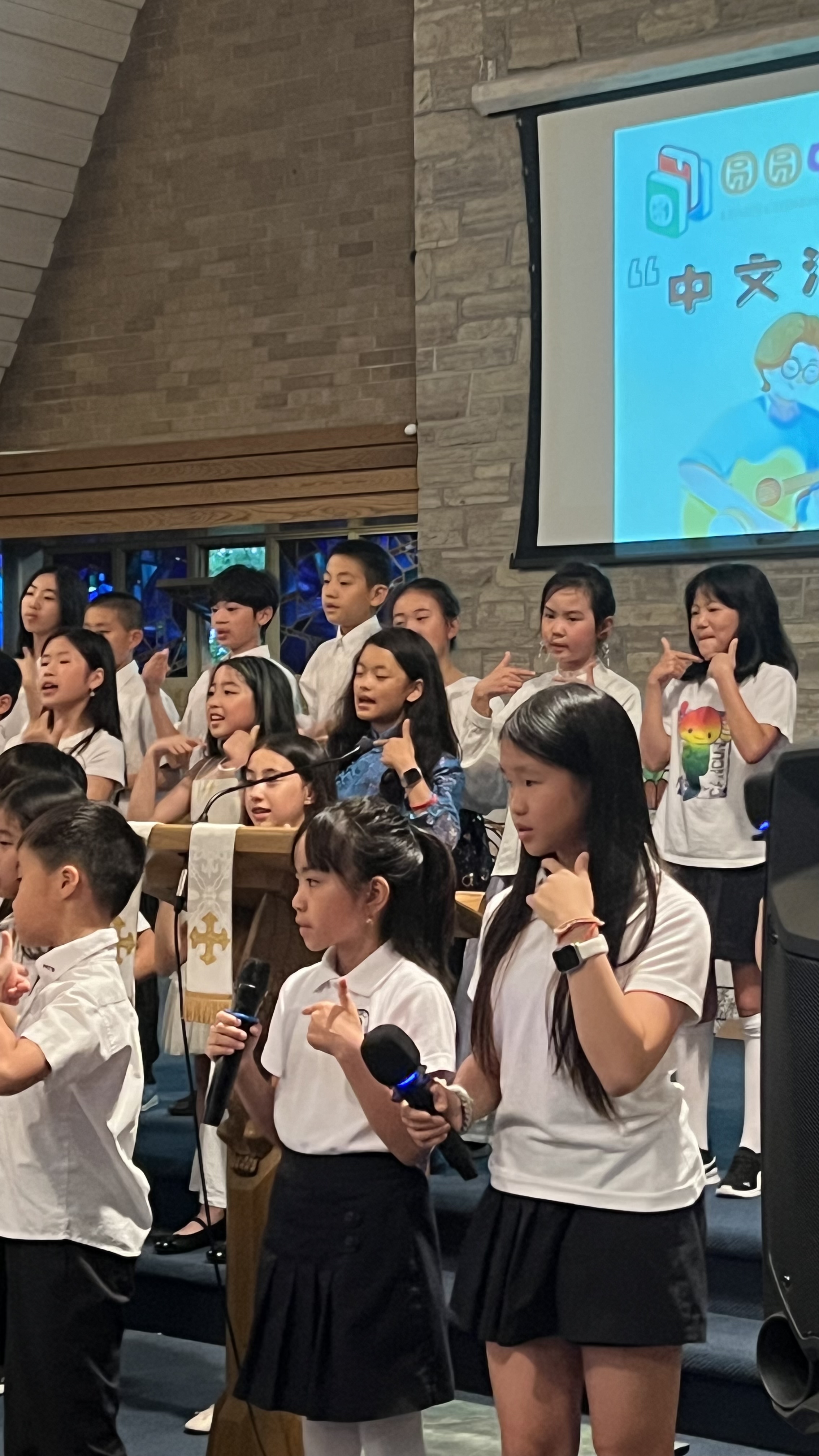 Mia performing with her choir group on stage