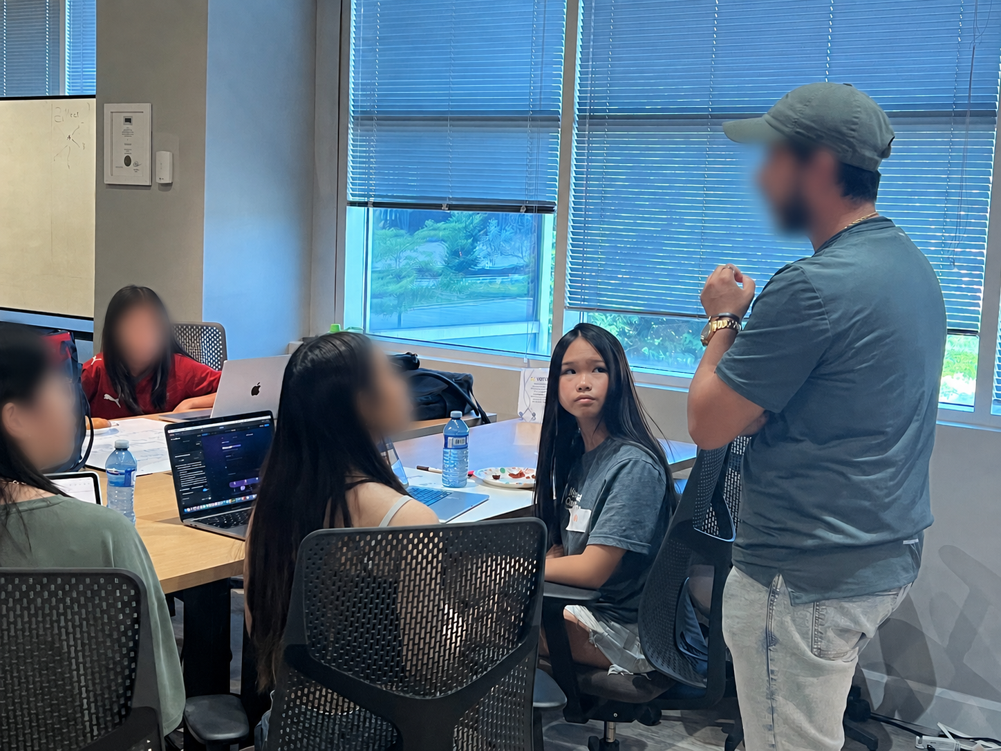 Mia at a coding workshop with teammates