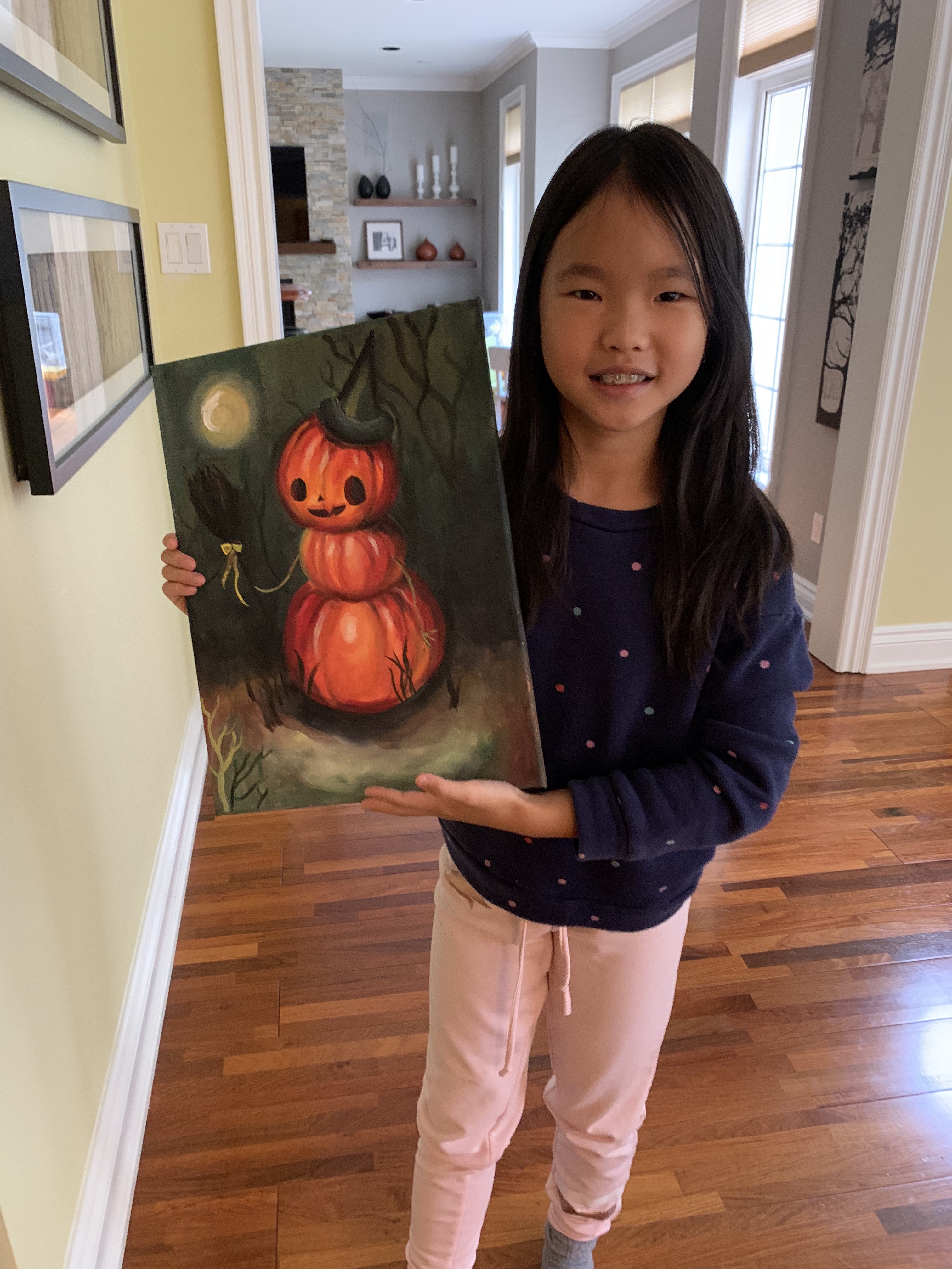 A painting of a stacked jack-o'-lantern character wearing a witch hat, holding a broom, under a full moon