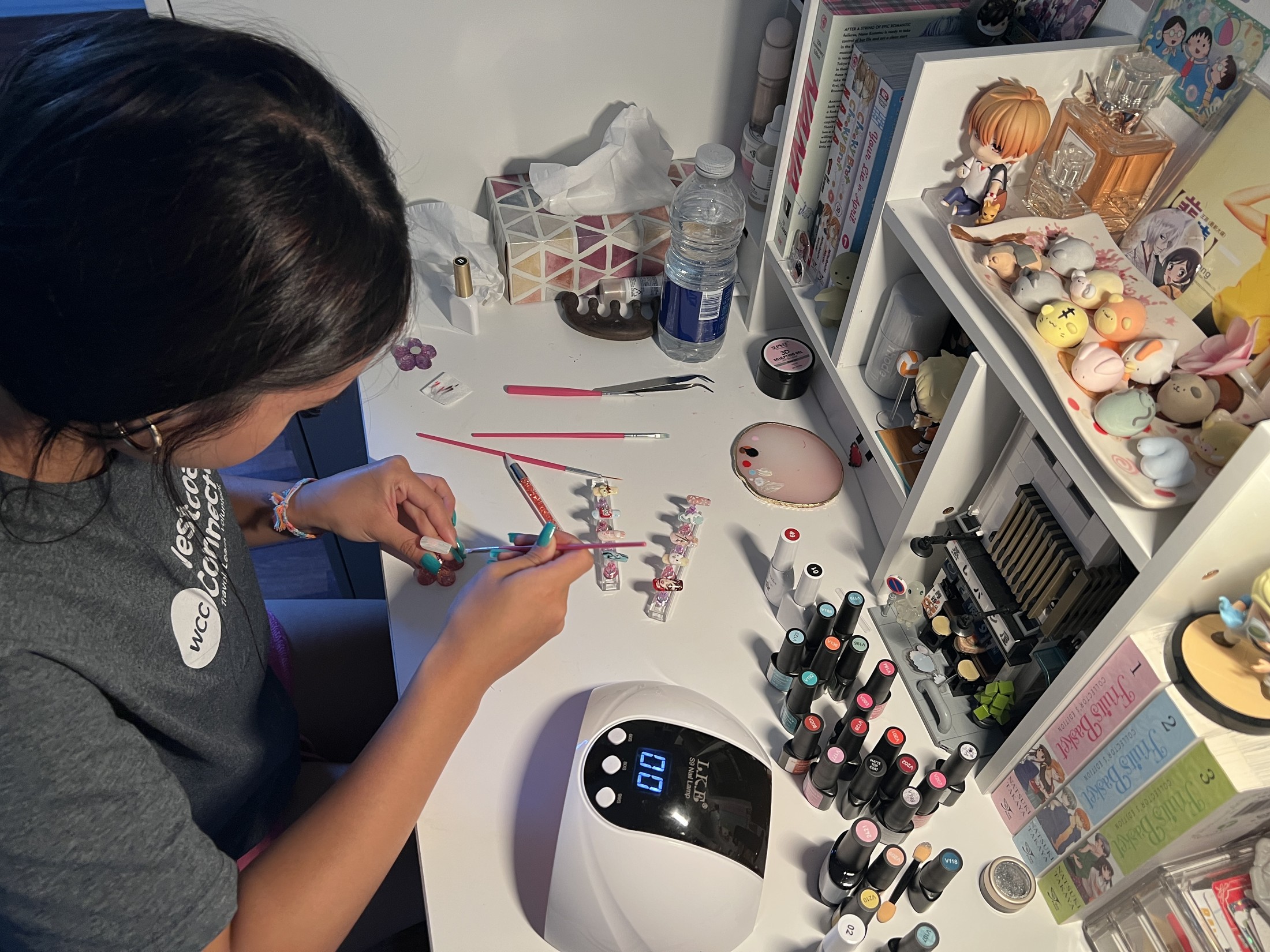 Mia working on nail art at her desk
