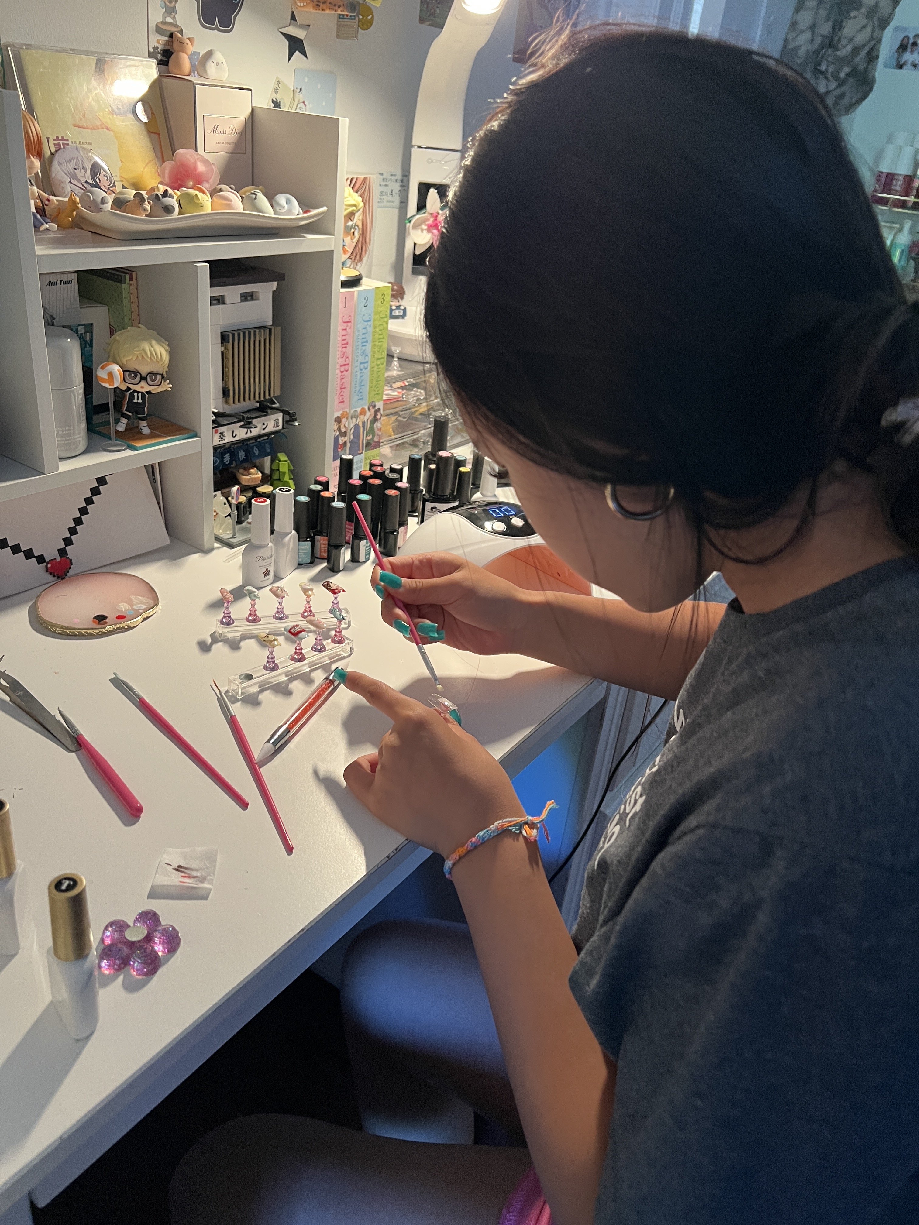 Mia practicing nail art at her desk