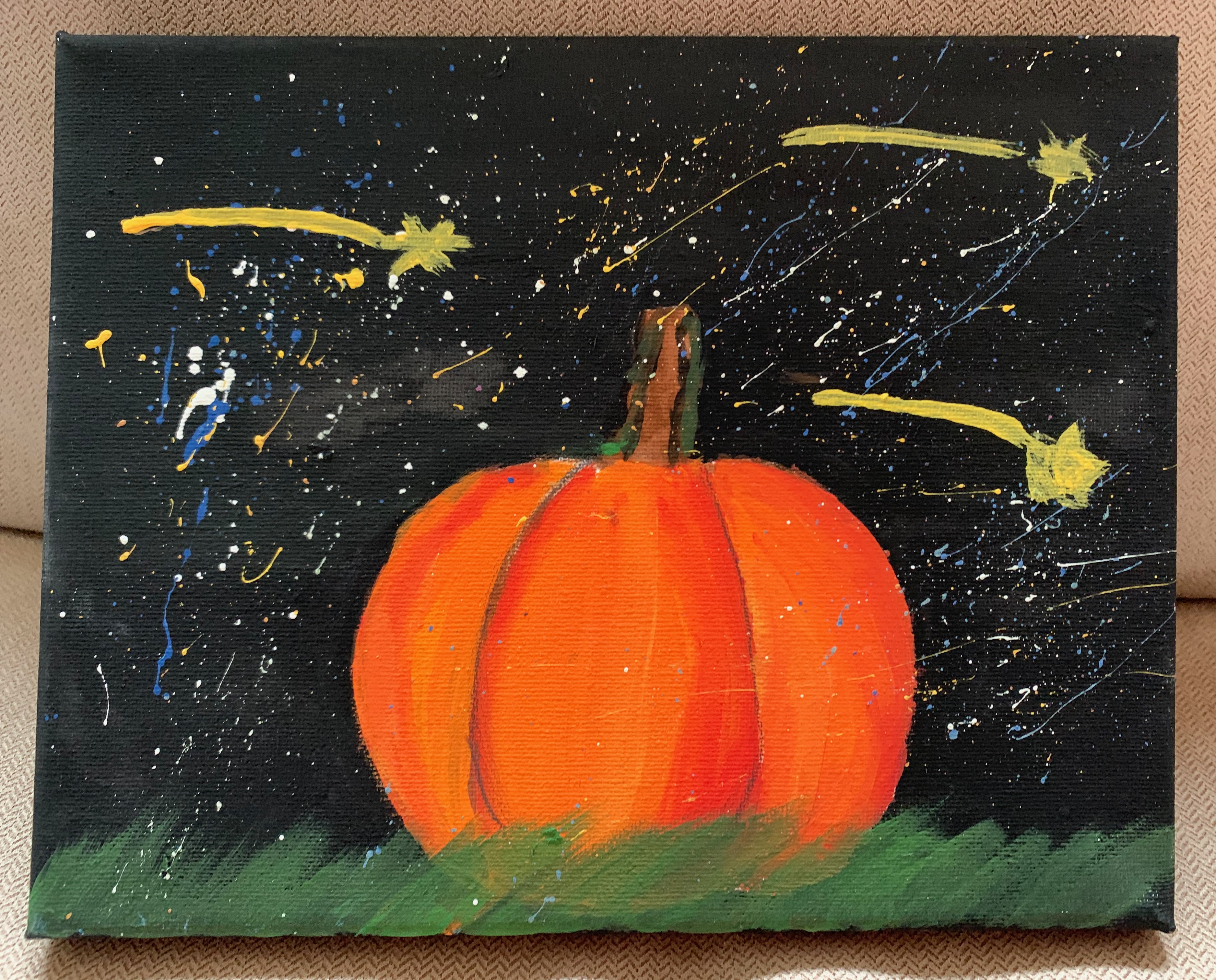 A painting of a pumpkin in a grassy patch under a splattered, star-filled night sky