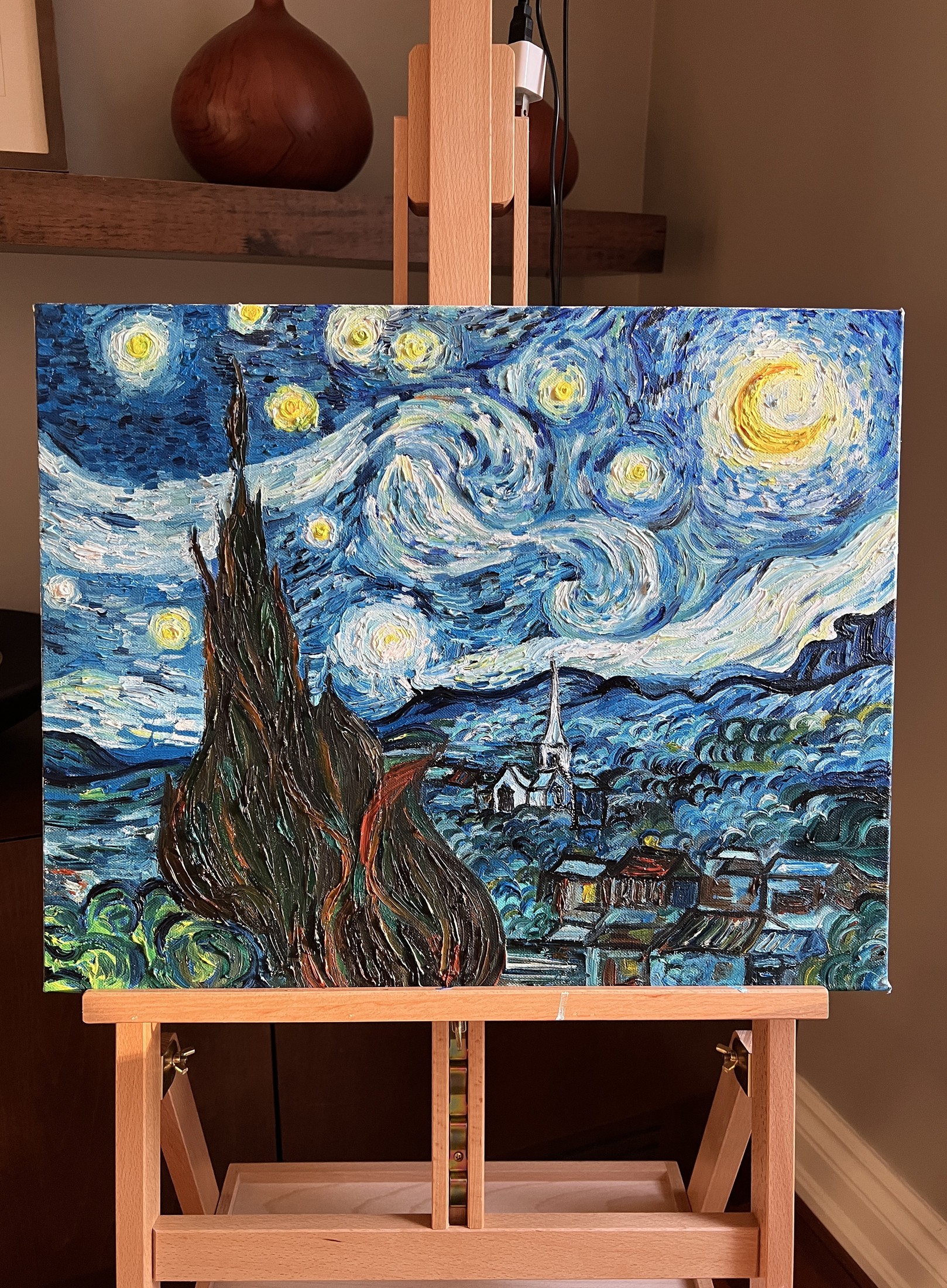A finished oil painting study of Van Gogh's Starry Night on an easel