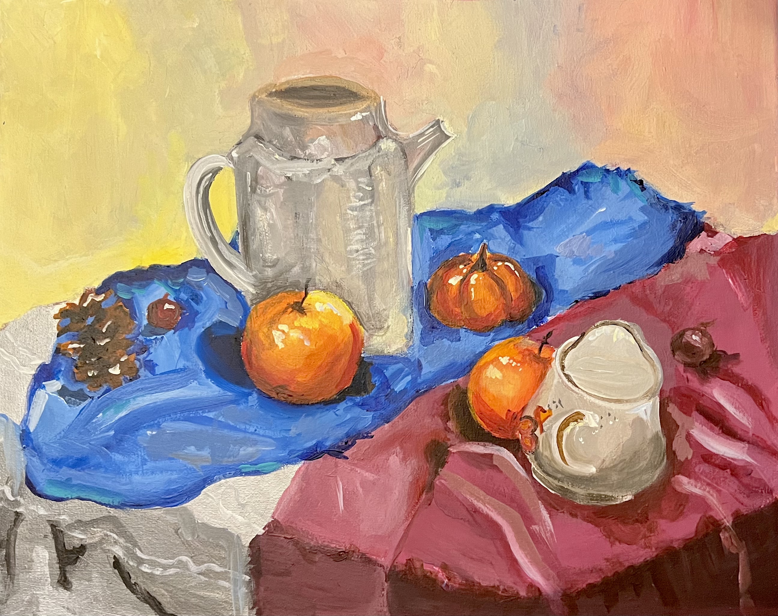 A still-life painting of a silver pitcher, oranges, mini pumpkins, a pinecone, and a teacup on blue and pink cloth