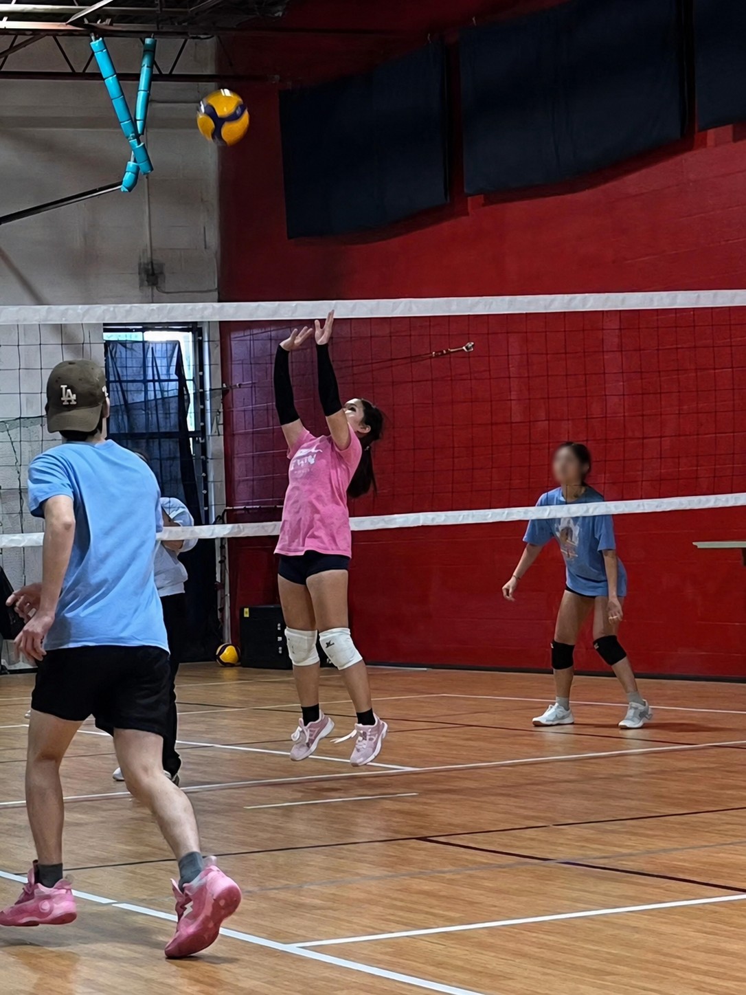 Mia setting the ball during a volleyball game
